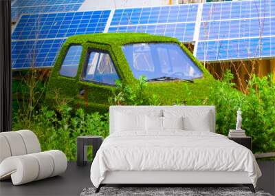 car covered in grass with solar panels in the background Wall mural