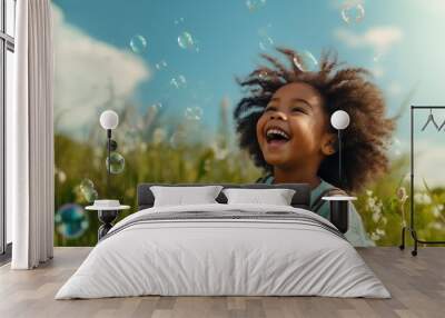 Happy african american little girl playing with soap bubbles in field Wall mural