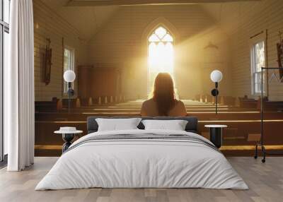 Sacred Moments. Solitary woman sitting in a sunlit church pew. Light streaming through the windows.  Wall mural