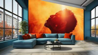 Young man praying in the smoke on the background of the rays of the sun. Worship. Wall mural