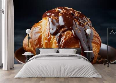 Golden freshly baked croissant drizzled with chocolate sauce on a plain background Wall mural