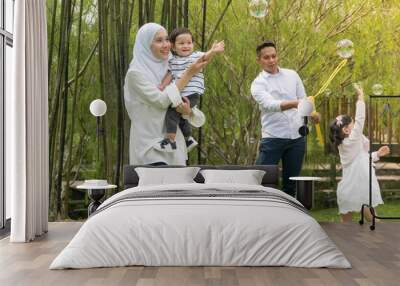 Malay family at recreational park having fun Wall mural