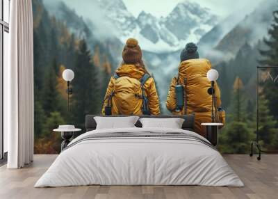 back view of two young people climbing a mountain Wall mural