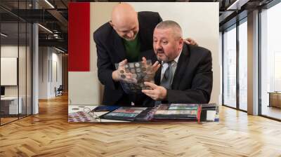 Two numismatists examines  collection of coin Wall mural