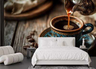 Turkish coffee being poured into a vintage cup against a wooden backdrop. Wall mural