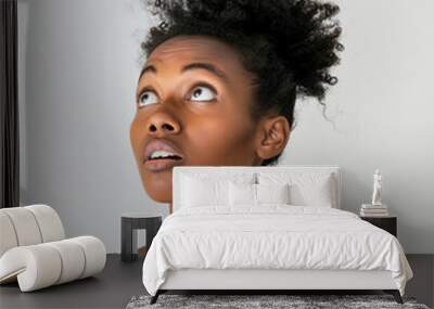 Close up portrait of a thinking and confused African American young woman in white top isolated on bright plain white background in the studio, with copy space. AI Wall mural