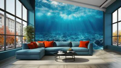 Dark blue water of a deep ocean with sun rays reaching the rocky seabed. Beautiful underwater landscape. Wall mural