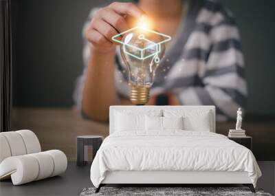 Hands-touching light bulb with graduation hat on wooden cubes stacked, Internet education course degree, E-learning graduate certificate program concept. study knowledge to creative thinking ideas. Wall mural