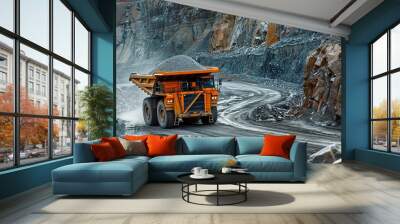 A heavy mining dump truck filled with stones on a dirt road within an active quarry environment Wall mural