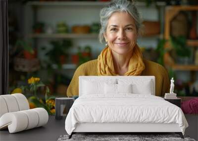 Joyful mature woman holding a box with clothing for donation, a symbol of generosity Wall mural