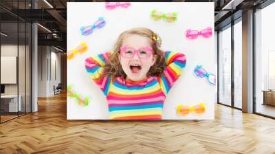 Child at eye sight test. Kid at optitian. Eyewear for kids. Wall mural