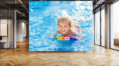 Child learning to swim. Kids in swimming pool. Wall mural