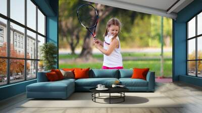 Child playing tennis on outdoor court Wall mural