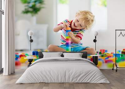 Child playing with toy blocks. Toys for kids. Wall mural