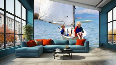 Child sailing. Kid learning to sail on sea yacht. Wall mural