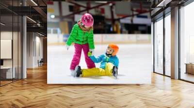 Child skating on indoor ice rink. Kids skate. Wall mural