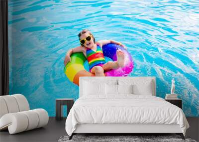 Child with toy ring in swimming pool Wall mural