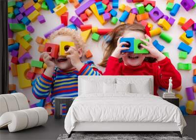 Children playing with colorful blocks. Wall mural