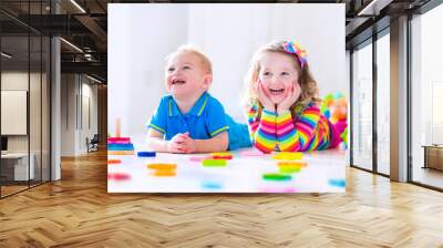 Cjildren playing with wooden toys Wall mural