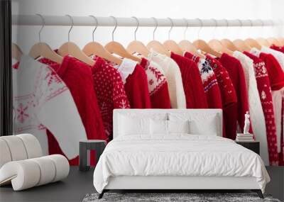 Clothes rack with red Christmas knit wear Wall mural