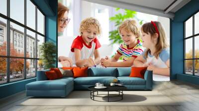 Family playing board game. Kids play. Wall mural