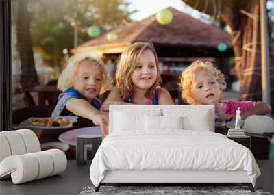 Family vacation lunch. Kids in beach restaurant Wall mural