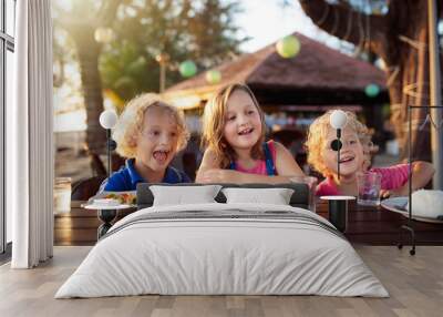 Family vacation lunch. Kids in beach restaurant Wall mural