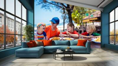 Family vacation lunch. Kids in beach restaurant Wall mural