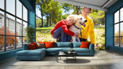 Family walking in autumn park. Fall fun. Wall mural