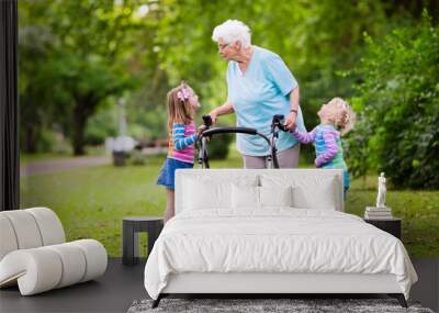 Grandmother with walker playing with two kids Wall mural