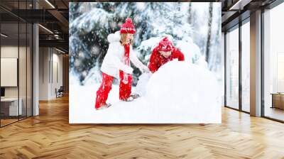 Kids building snowman. Children in snow. Winter fun. Wall mural