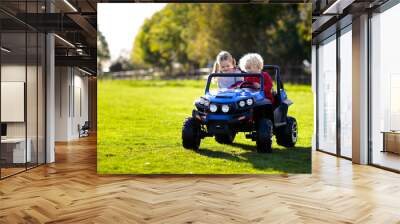 Kids driving electric toy car. Outdoor toys. Wall mural