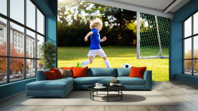 Kids play football. Child at soccer field. Wall mural