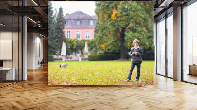 Kids play in autumn park Wall mural