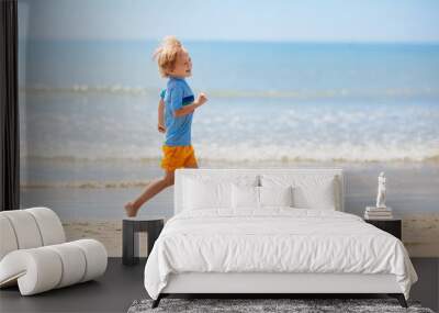 Kids playing on beach. Children play at sea. Wall mural