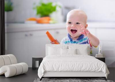 Little baby eating carrot Wall mural