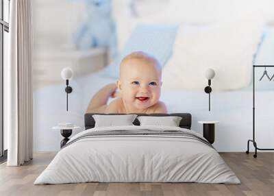 Little baby on white bed Wall mural