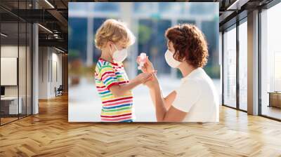 Mother and child with face mask and hand sanitizer Wall mural