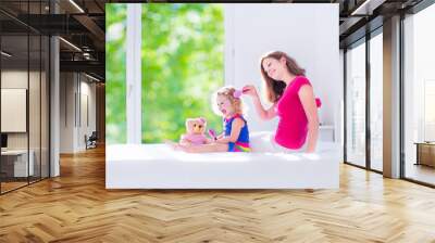 Mother and daughter brushing hair Wall mural