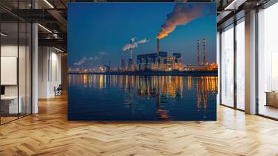 At sunset, the chimney of the power plant by the river emitted thick smoke Wall mural