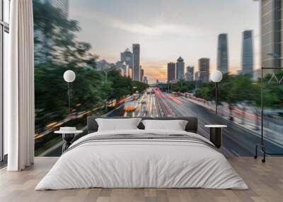 light trails on city street with cityscape at dusk in China. Wall mural