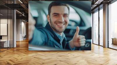 happy young bearded man sitting in car and showing thumb up Wall mural