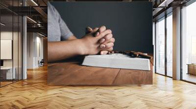 woman praying on a book with a cross Wall mural