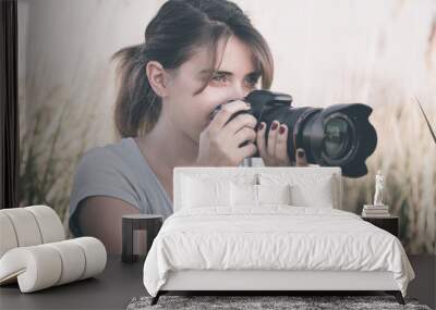 Vintage portrait of a beautiful young woman who likes to take pictures of nature Wall mural