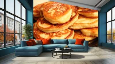 Pancakes sprinkled with sugar on a black plate. Pancakes with milk. Close-up. Wall mural