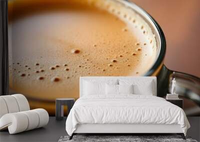 Close-up of a cup of freshly brewed coffee, showing the rich, foamy texture and dark brown color of the liquid Wall mural