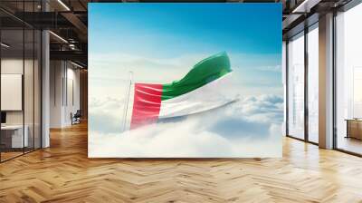 United Arab Emirates national flag hidden in the sky. The flag with drone shot in beautiful clouds. UAE national flag for independence day. Wall mural