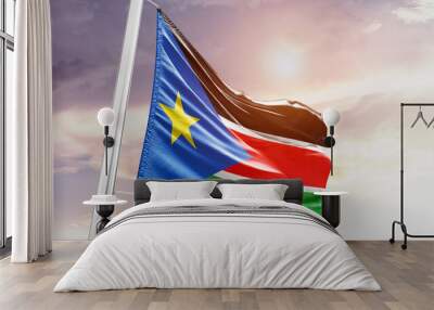 Waving Flag of South Sudan in Blue Sky. The symbol of the state on wavy cotton fabric. Wall mural