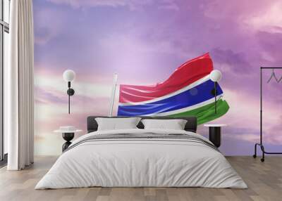 Waving Flag of The Gambia in Blue Sky. The symbol of the state on wavy cotton fabric. Wall mural