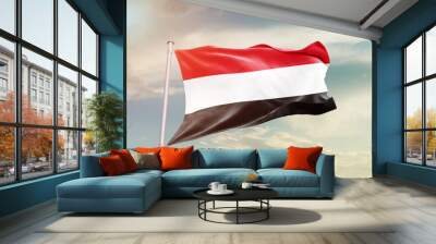 Yemen national flag waving in beautiful sky. The symbol of the state on wavy silk fabric. Wall mural